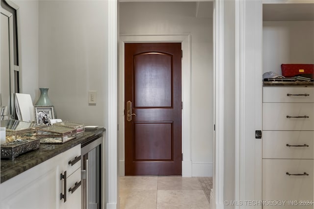 interior space featuring tile patterned floors and beverage cooler