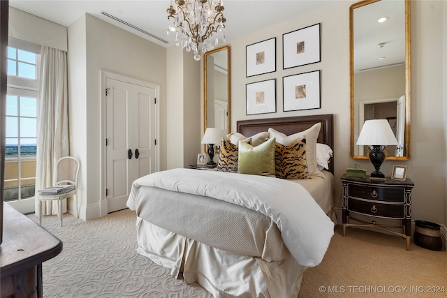 carpeted bedroom featuring a chandelier