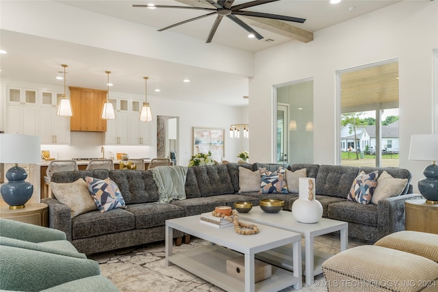 living room featuring ceiling fan and beamed ceiling