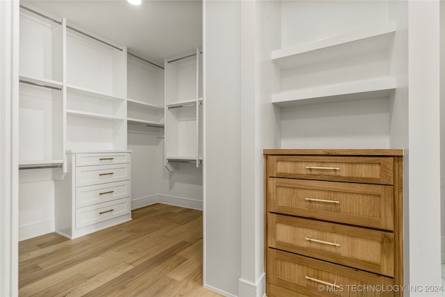 spacious closet with light hardwood / wood-style floors