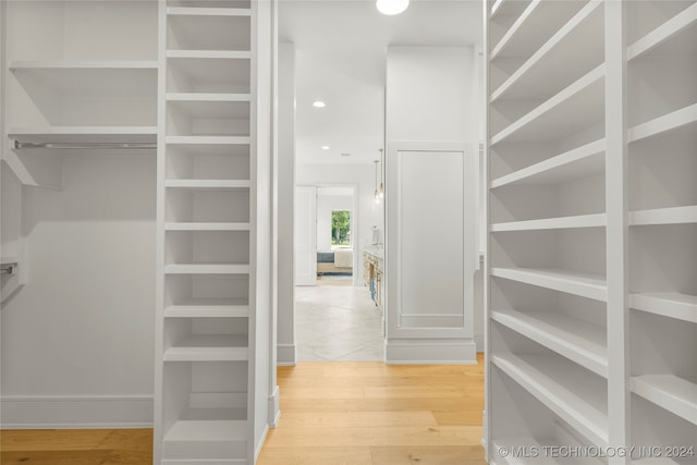 spacious closet featuring hardwood / wood-style flooring