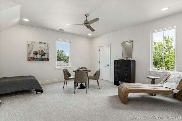 bedroom with ceiling fan, lofted ceiling, multiple windows, and light colored carpet