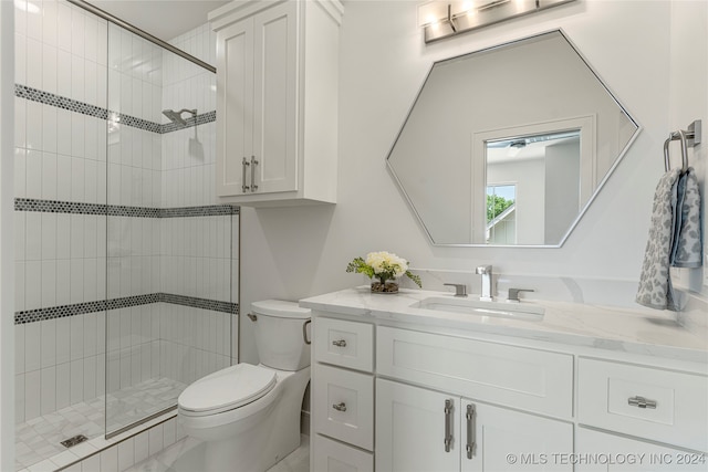 bathroom featuring toilet, walk in shower, and vanity