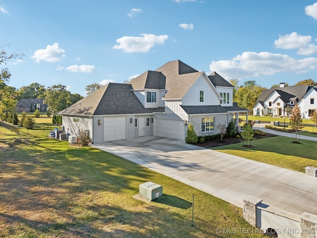 view of front of house with cooling unit, a front lawn, and a garage