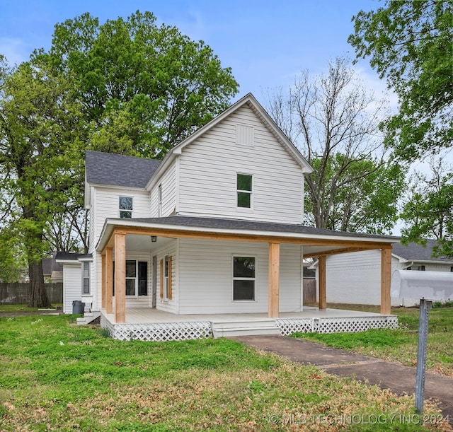 view of front of property with a front yard and covered porch