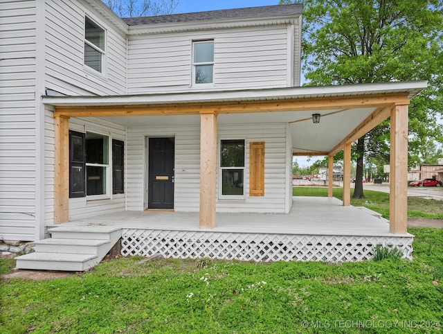 exterior space featuring a porch and a lawn