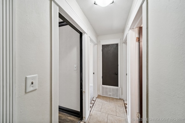 corridor with light tile patterned flooring