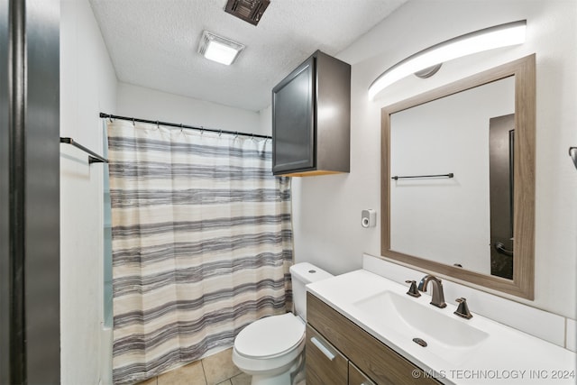 bathroom with toilet, a shower with curtain, tile patterned floors, vanity, and a textured ceiling