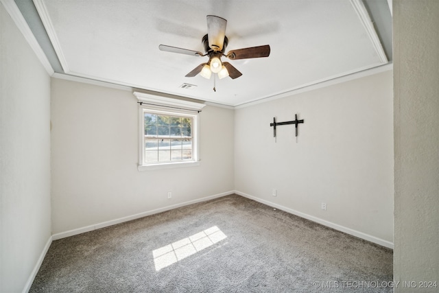 empty room featuring ceiling fan, carpet flooring, and ornamental molding