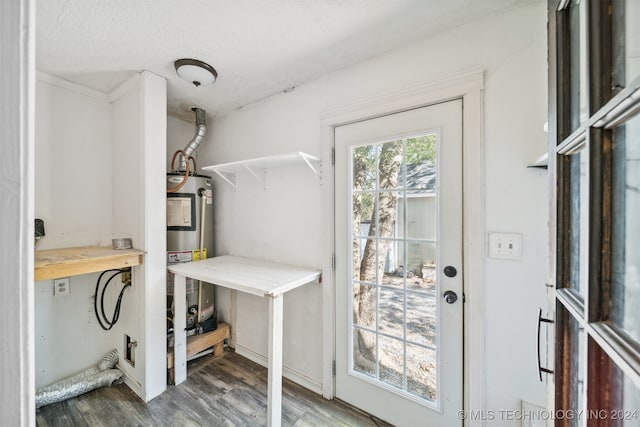 interior space with dark hardwood / wood-style floors, water heater, and a textured ceiling