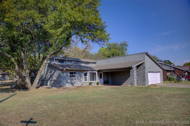 view of front of house with a front yard and a garage