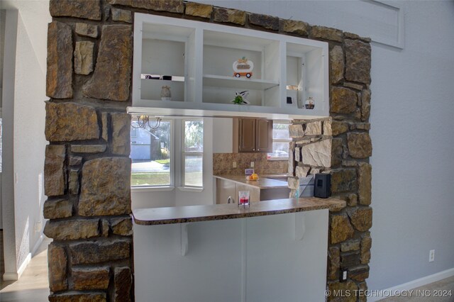 kitchen featuring decorative backsplash and light hardwood / wood-style flooring