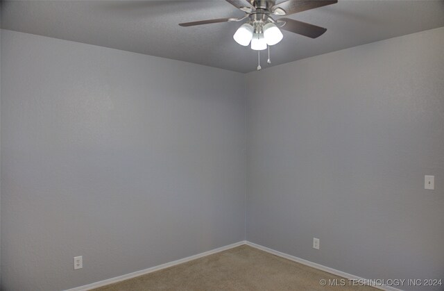 unfurnished room with ceiling fan and carpet flooring