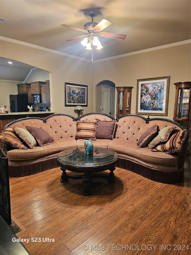 living room with ornamental molding, hardwood / wood-style flooring, and ceiling fan