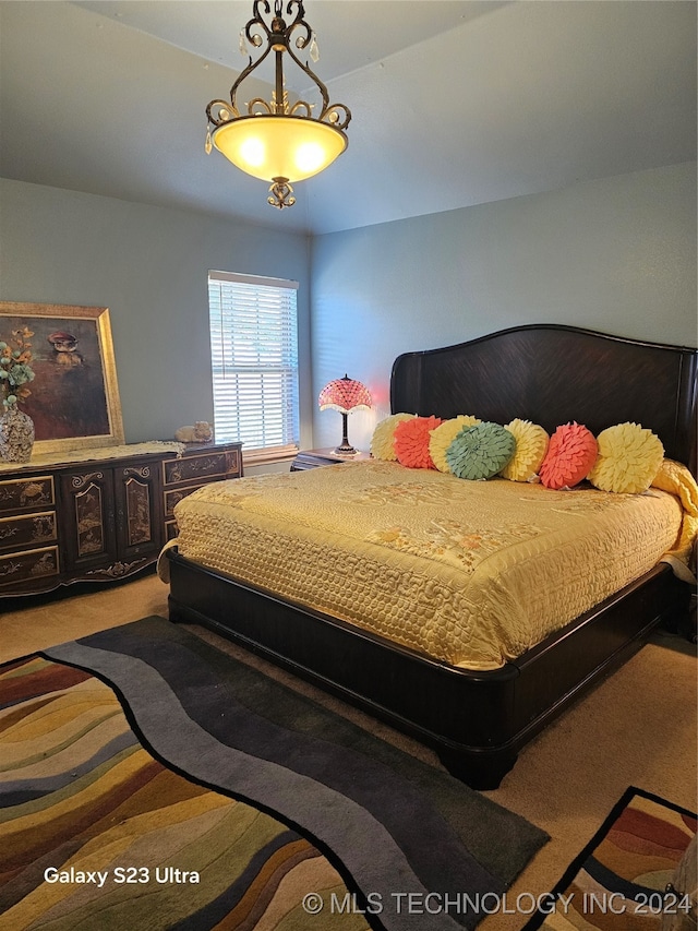 carpeted bedroom with vaulted ceiling