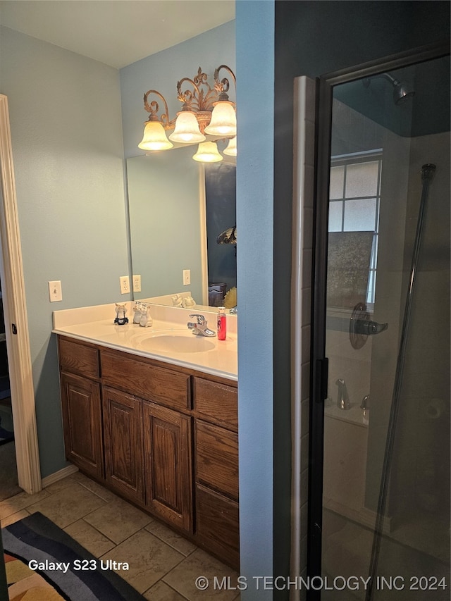 bathroom with vanity, walk in shower, and tile patterned flooring