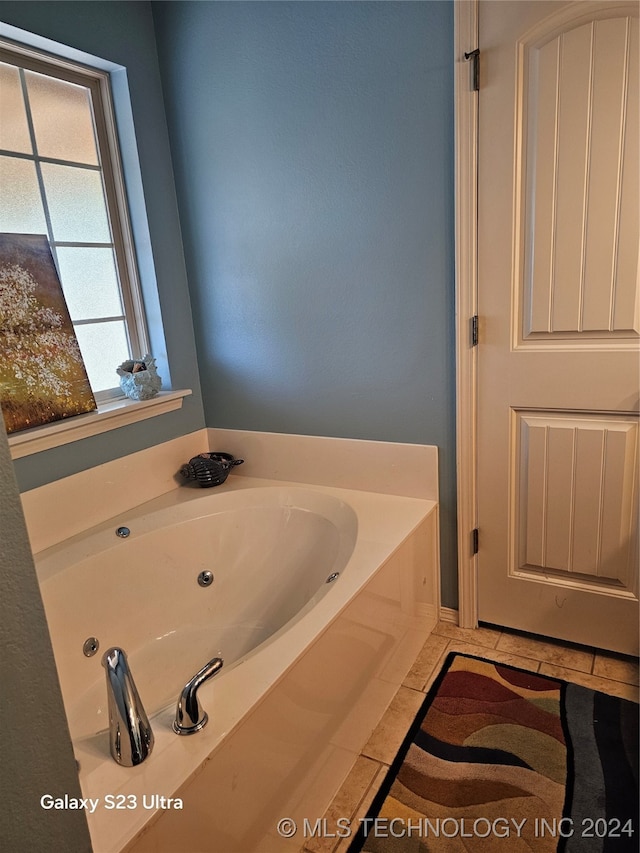 bathroom featuring a bath and tile patterned flooring