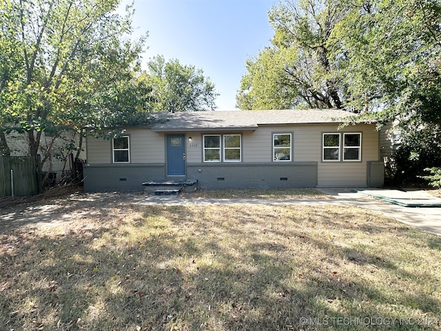 ranch-style home featuring a front yard