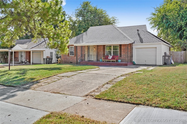 single story home featuring a garage, a porch, and a front lawn