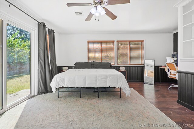 bedroom with ceiling fan, access to outside, dark wood-type flooring, and multiple windows