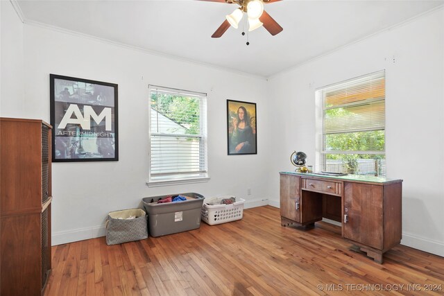 office space featuring plenty of natural light, ornamental molding, hardwood / wood-style floors, and ceiling fan