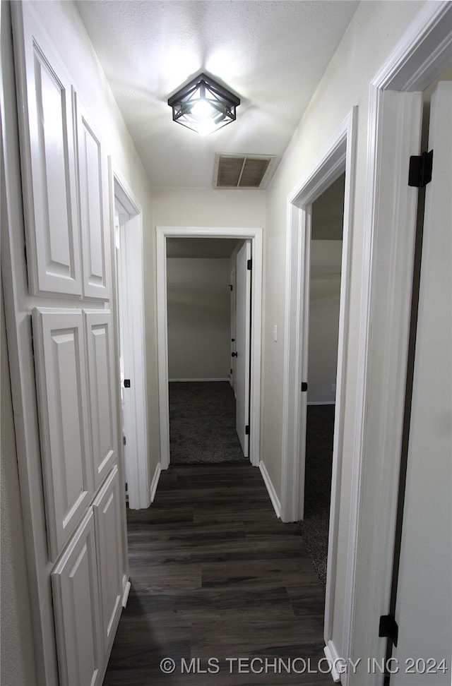 hallway with dark wood-type flooring