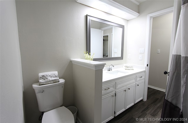 bathroom featuring hardwood / wood-style floors, vanity, and toilet