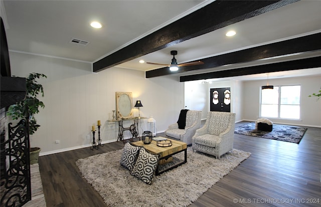 living room with beamed ceiling, dark hardwood / wood-style flooring, ceiling fan, and crown molding