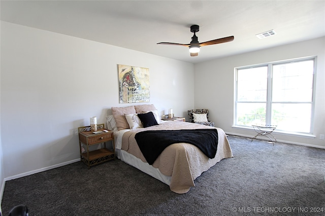 bedroom featuring ceiling fan and dark carpet