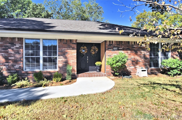 property entrance with a yard