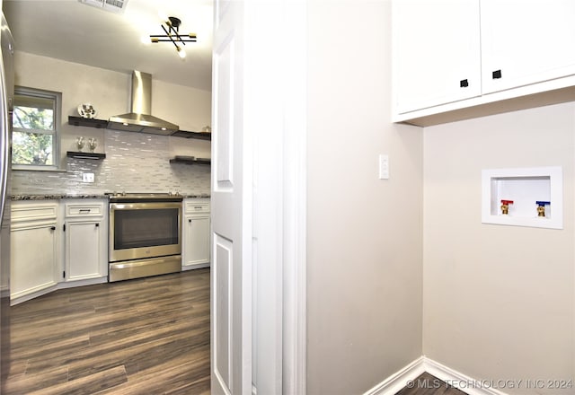 kitchen with tasteful backsplash, dark wood-type flooring, wall chimney range hood, electric stove, and white cabinetry