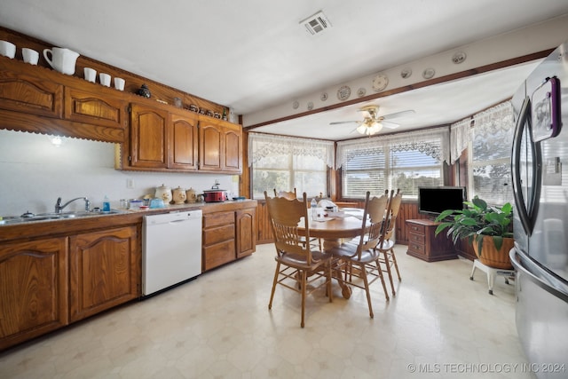 kitchen featuring sink, dishwasher, ceiling fan, and stainless steel refrigerator