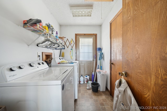 clothes washing area with a textured ceiling and washer and clothes dryer