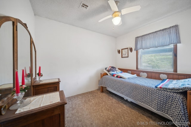 bedroom with light carpet, a textured ceiling, and ceiling fan