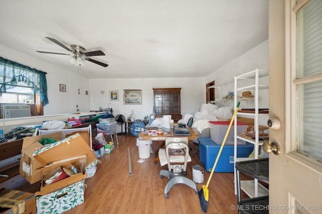 interior space with light hardwood / wood-style flooring, cooling unit, and ceiling fan