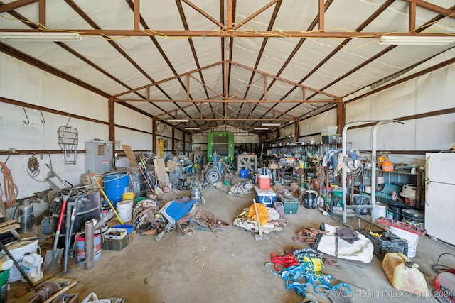 garage with white fridge and a workshop area