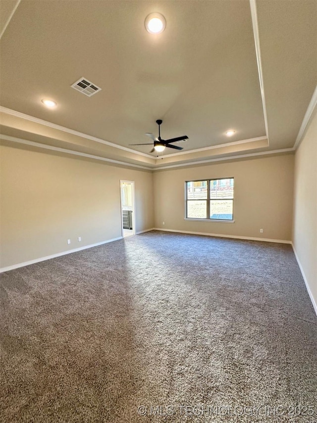 carpeted empty room featuring crown molding, ceiling fan, and a tray ceiling