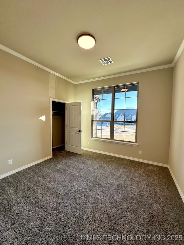 unfurnished bedroom with ornamental molding, carpet flooring, and a closet