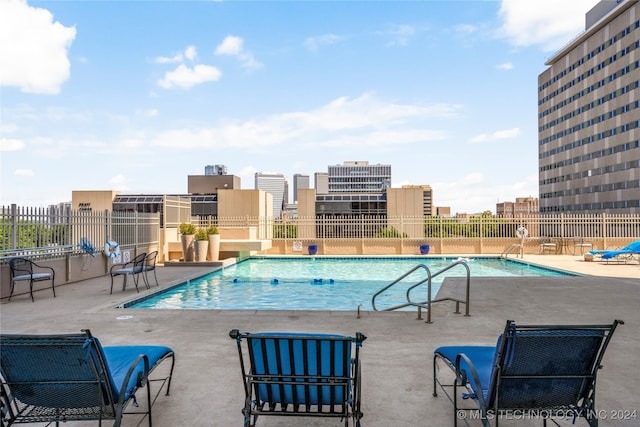 view of swimming pool featuring a patio area