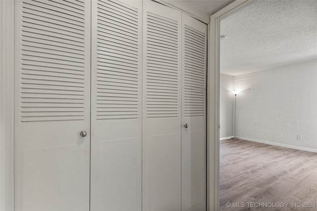 details with hardwood / wood-style flooring and a textured ceiling