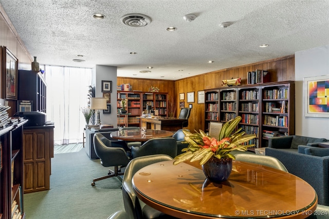 interior space with wooden walls and a textured ceiling