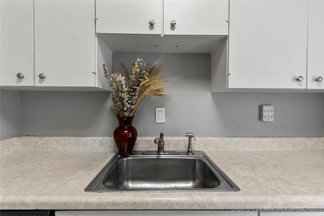 kitchen featuring sink and white cabinetry