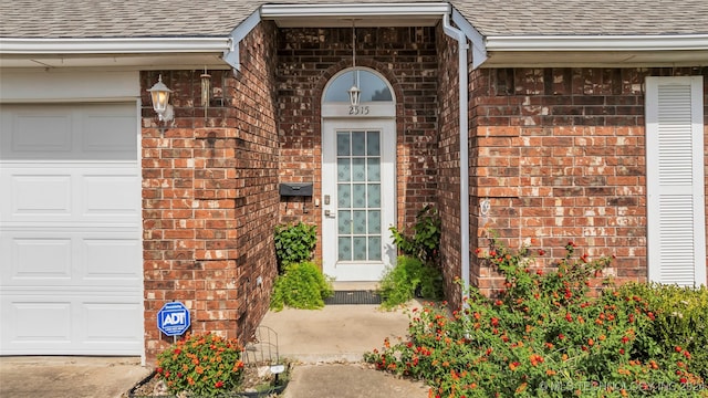 view of exterior entry with a garage