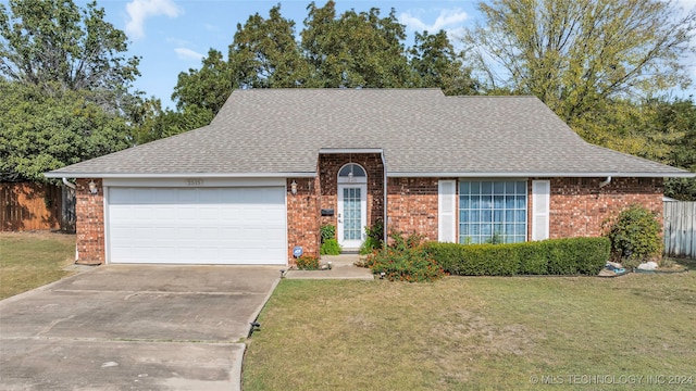 view of front of home featuring a garage and a front lawn