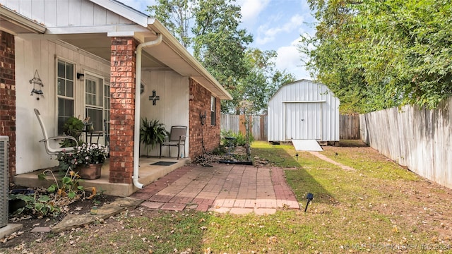 view of yard with a shed and a patio