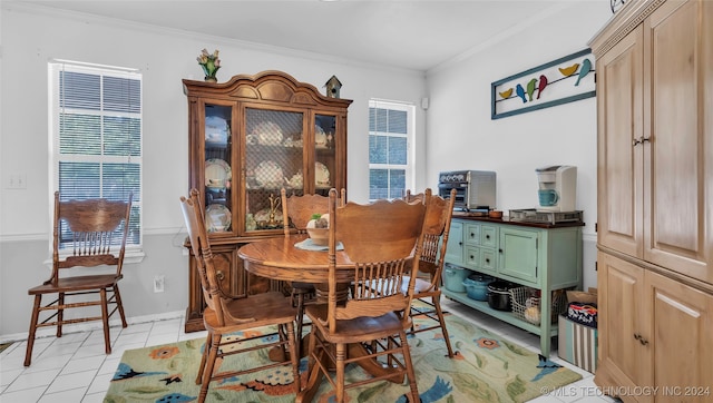 tiled dining space featuring ornamental molding and a healthy amount of sunlight