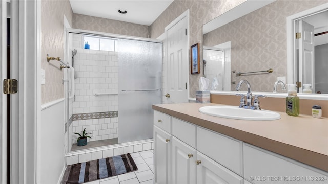 bathroom featuring vanity, tile patterned flooring, and walk in shower