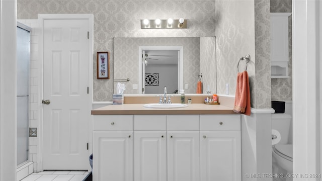 bathroom with vanity, a shower with shower door, toilet, and tile patterned flooring