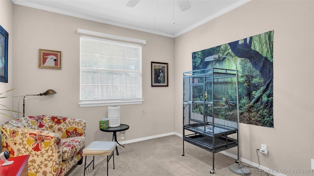 sitting room featuring light carpet, crown molding, and ceiling fan