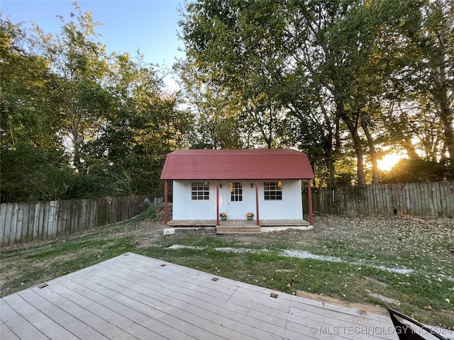 wooden terrace with a storage shed